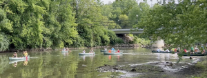 Several canoes paddle down the white river in Indiana.